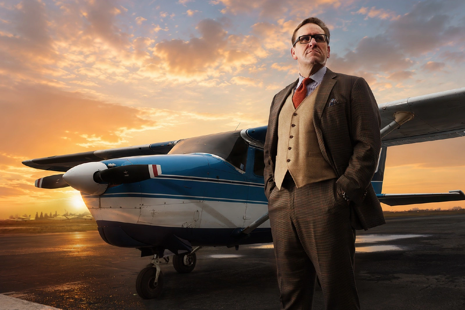 Final cinematic composite of a man beside a blue aircraft at sunset